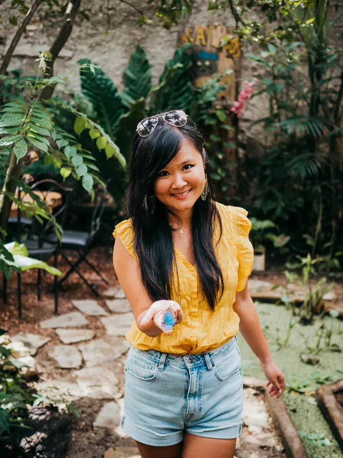Nan holding a butterfly in the mariposa garden of Maracuya