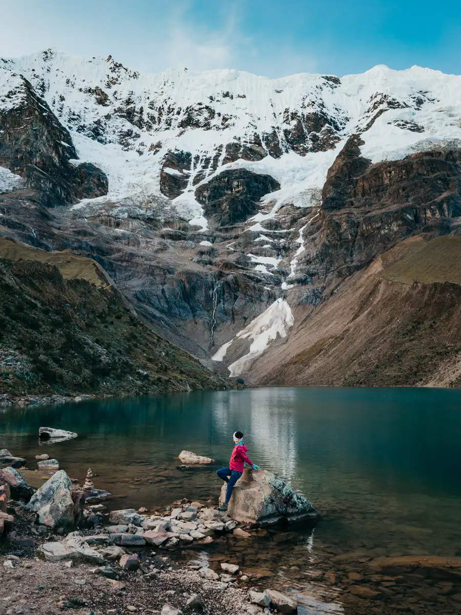 woman standing near lake at humantay lake