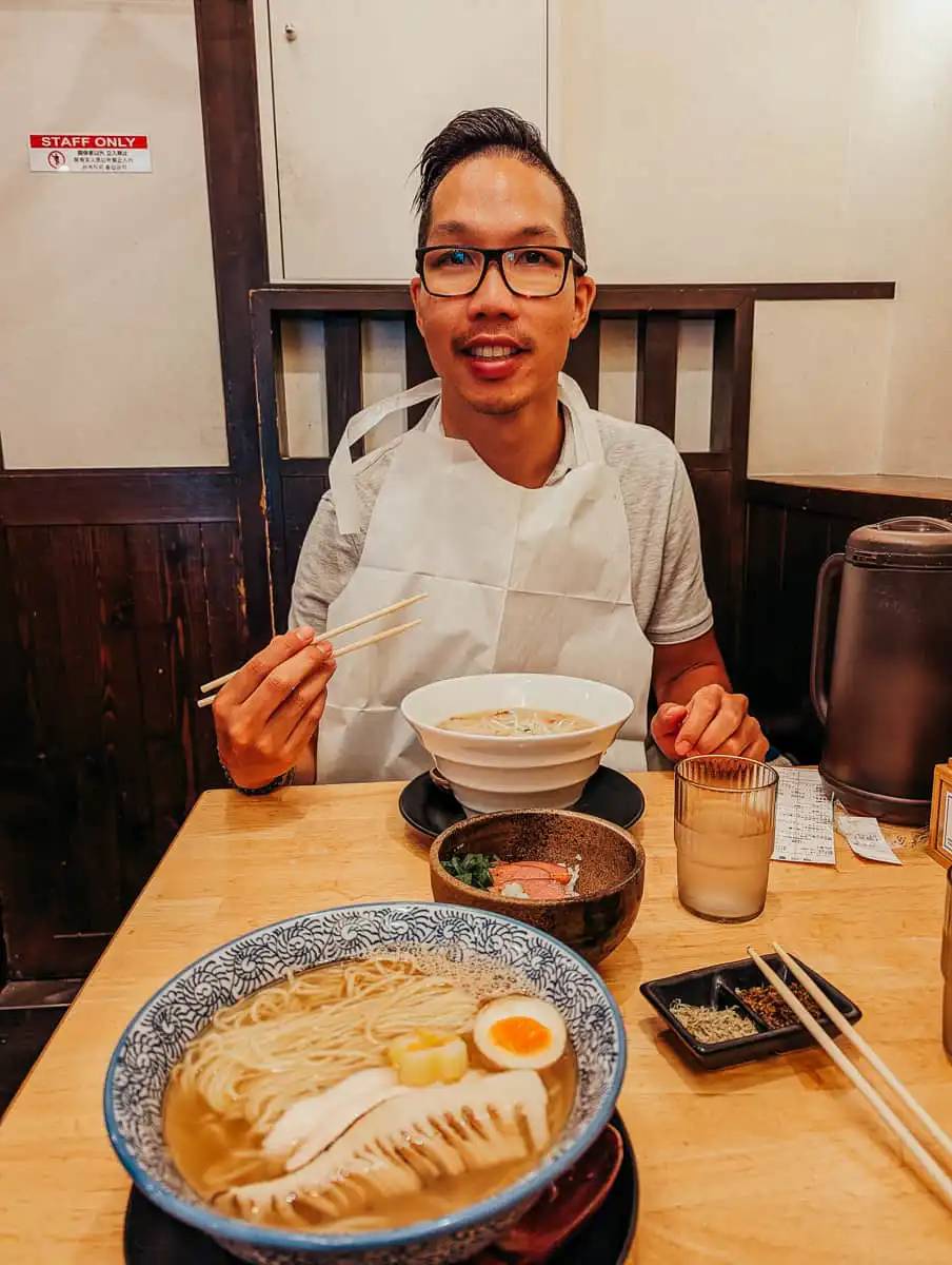 man eating ramen during our 2 days kyoto itinerary