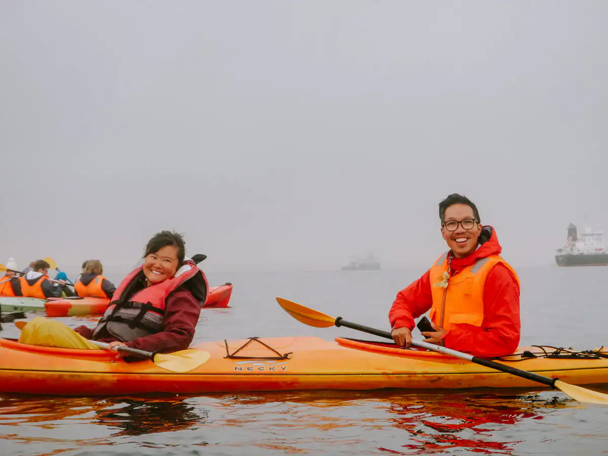 Man and woman sitting in kayak at pelican point