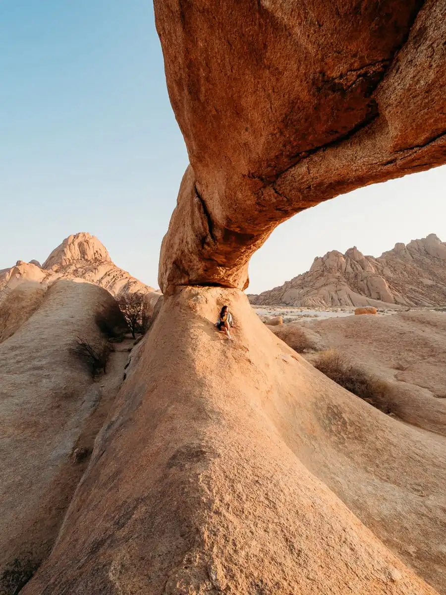 Sitting under the rock arch in Spitzkoppe