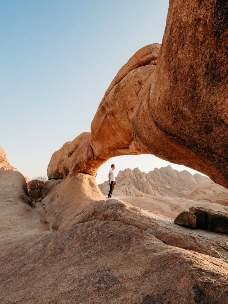 Standing under the rock arch at Spitzkoppe