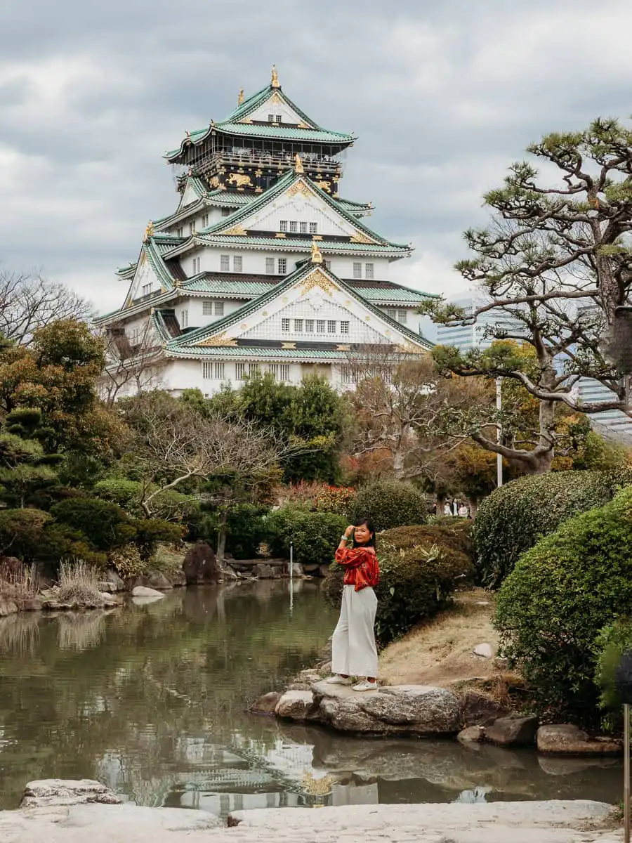 Woman standing in front of osaka castle