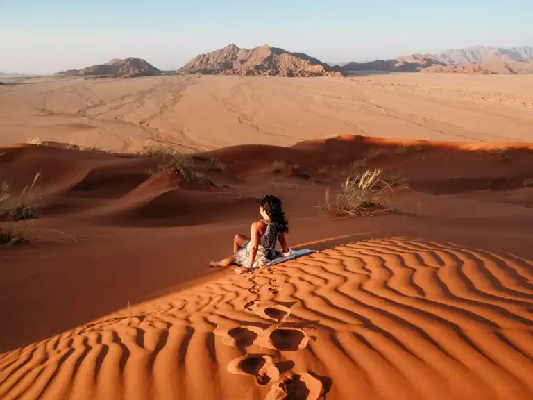 Sitting on the sands of elim dunes at sunset