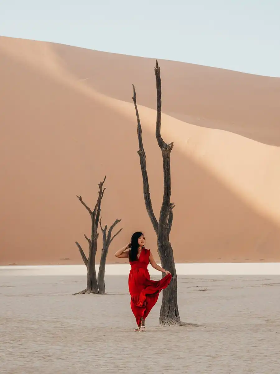 Woman standing next to tree in Deadvlei