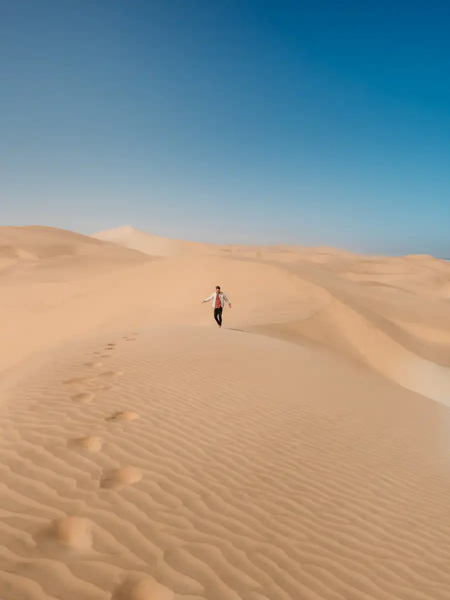 Man walking on the sand at sandwich harbour
