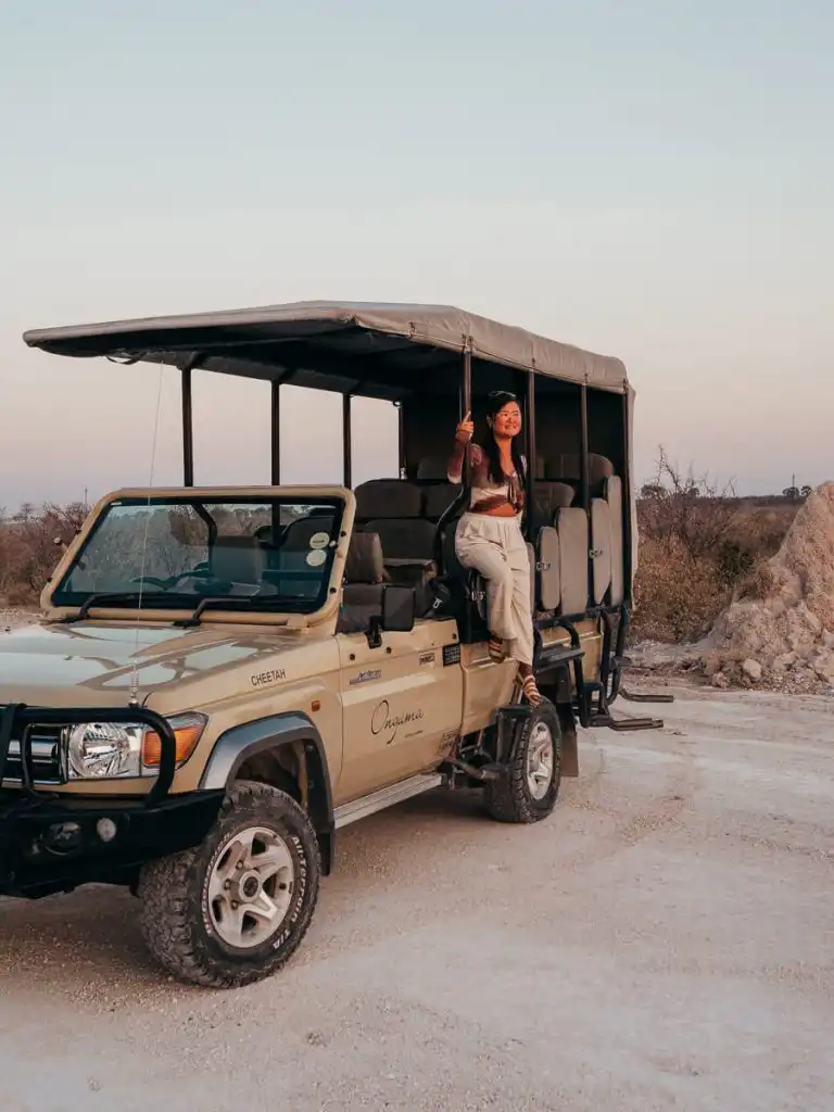 Woman sitting on game vehicle in Etosha