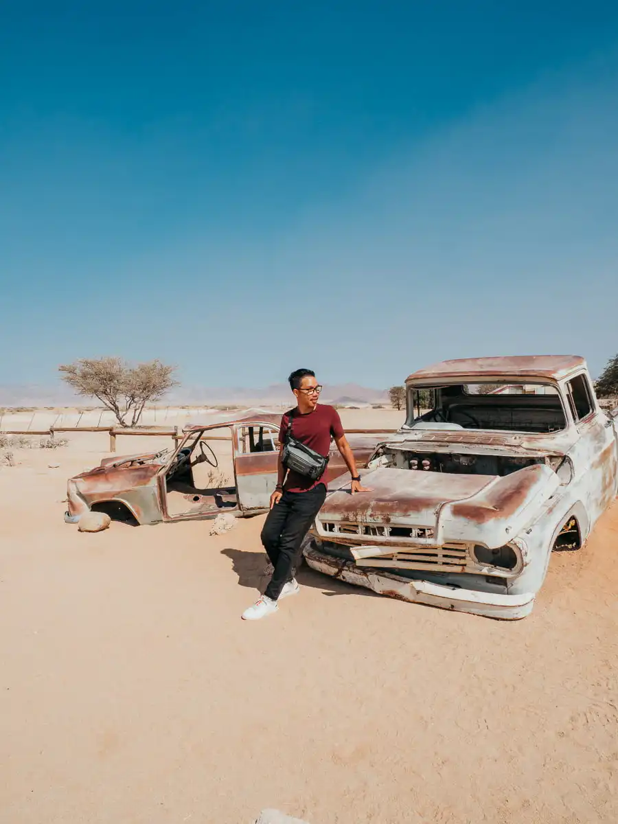 Posing next to a vintage car in Solitaire Namibia