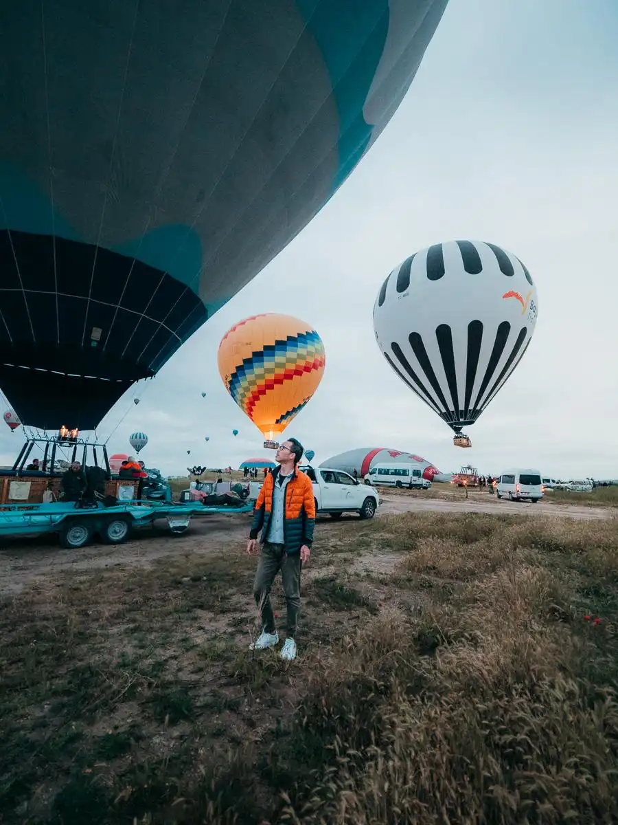 Man standing in front of inflating hot air balloon in Cappadocia
