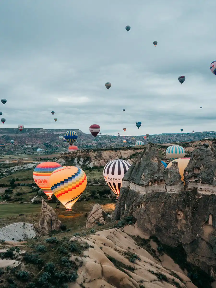 Hot air balloons flying in the air in Cappadocia