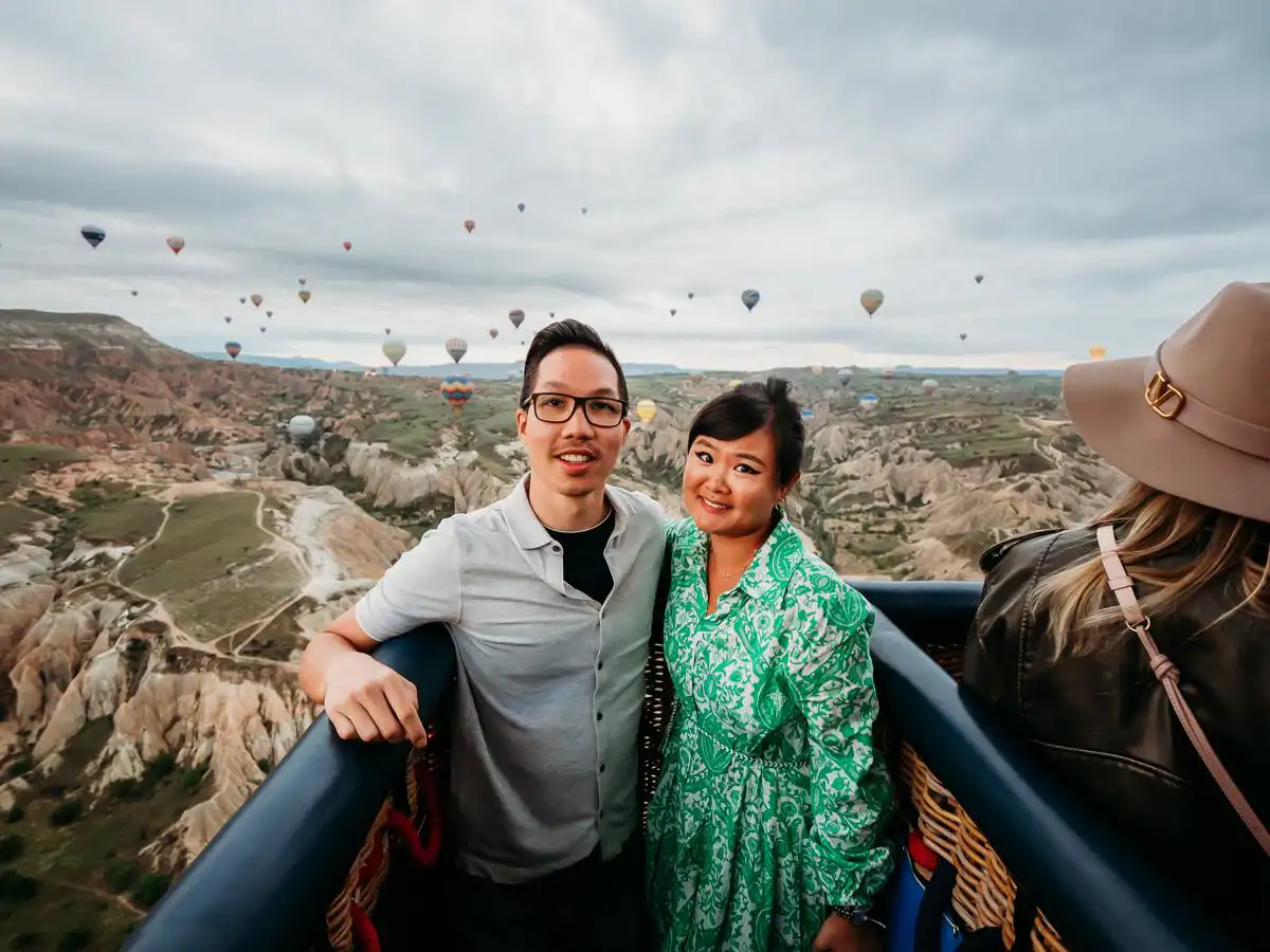 woman and man high up in the air in the hot air balloon