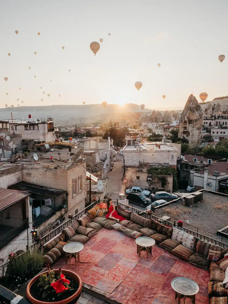 Sitting on the balcony in Cappadocia watching the sunset with the hot air balloons, during our 10 day Turkey Itinerary