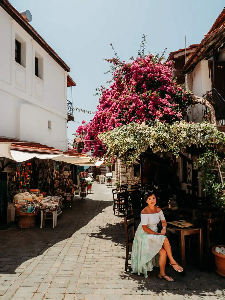 sitting under a pink flower tree in Kas