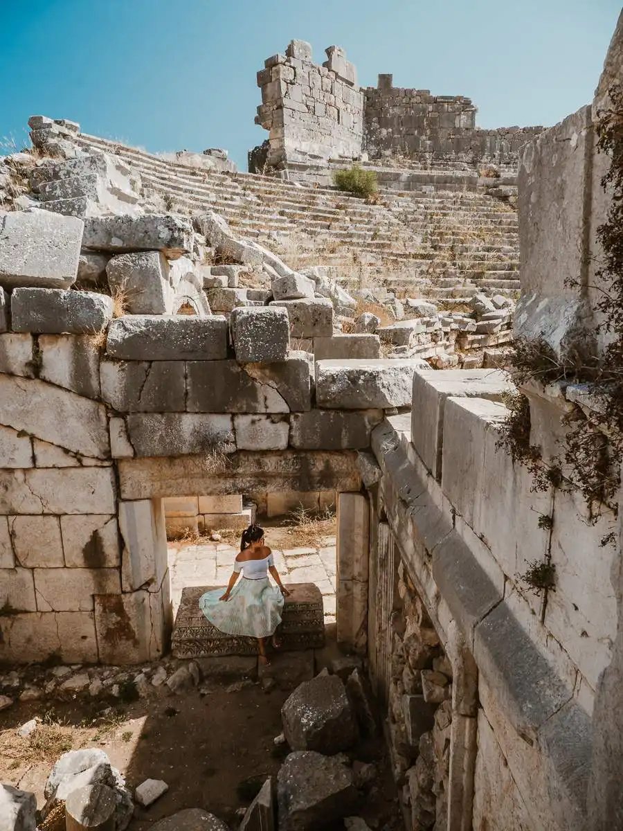 Patara ruins nearby Kas, woman sitting on the stones