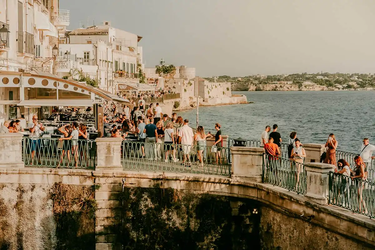 People nearby the Aretusa Fountain in Syracuse