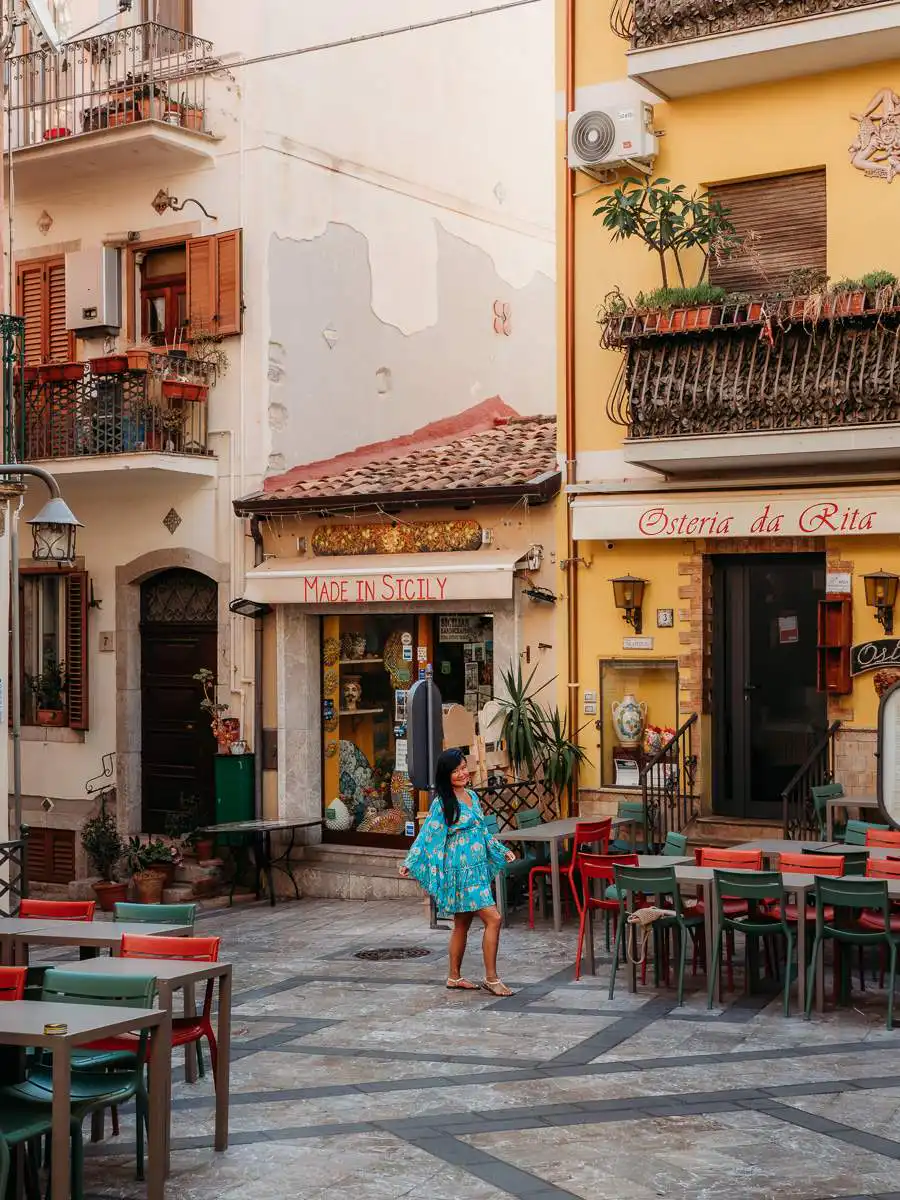 Woman standing in front of shop in Taormina