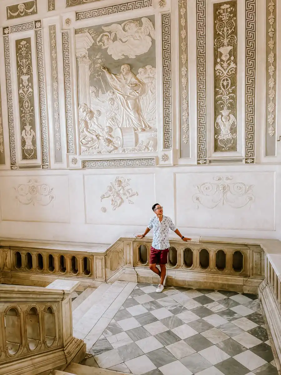 standing in the hallway of the Benedettini stairway