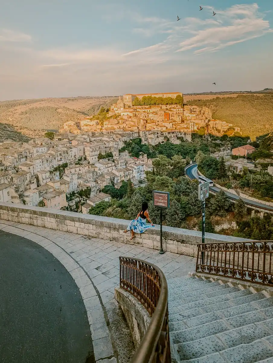 Sitting at the staircase of Ragusa with views of Ragusa Ibla