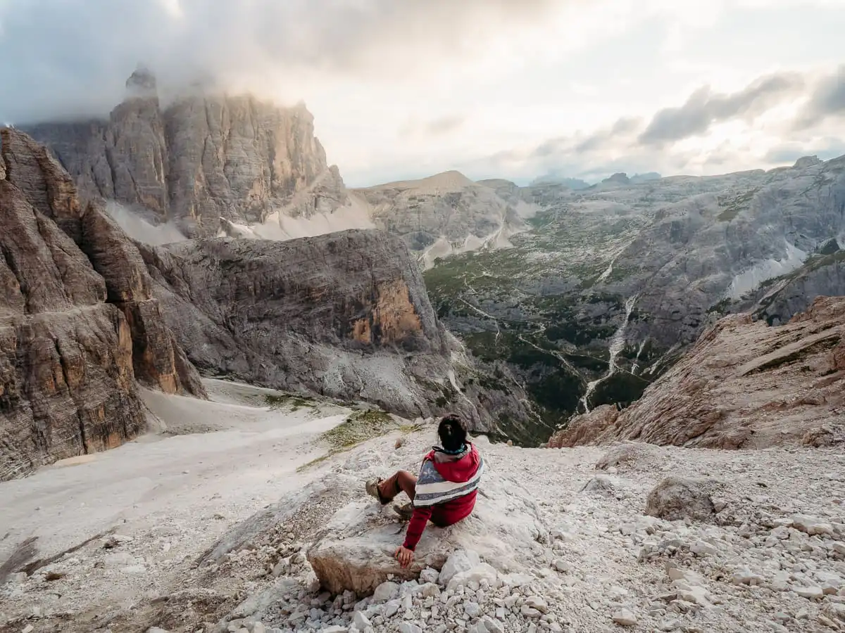 Woman sitting for sunset at tre cime de lavarado
