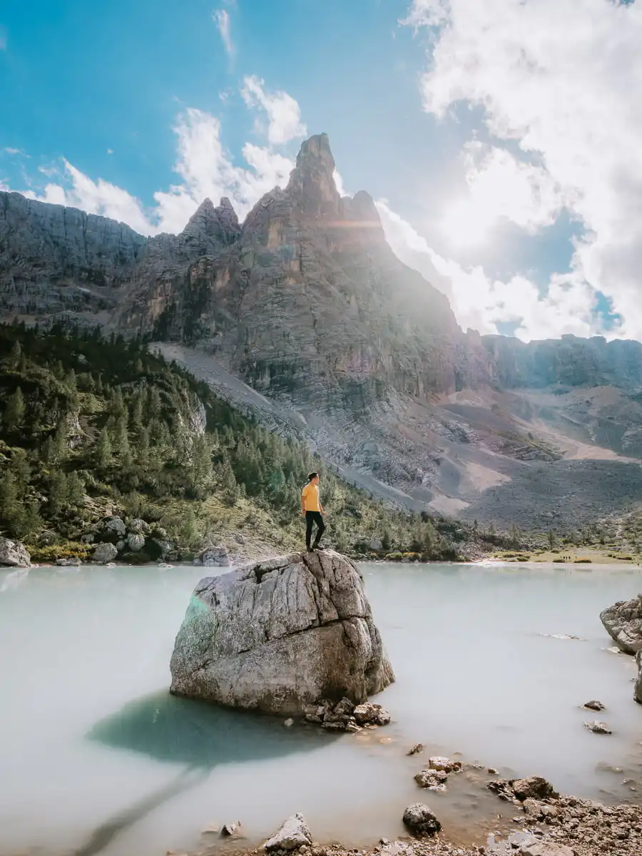 Man standing on top of rock at Lago di Sorapis