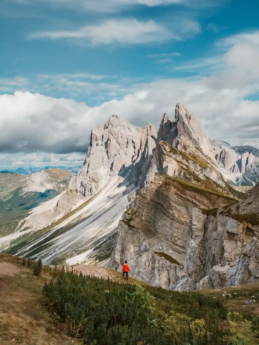 standing on the ridge of seceda with red jacket
