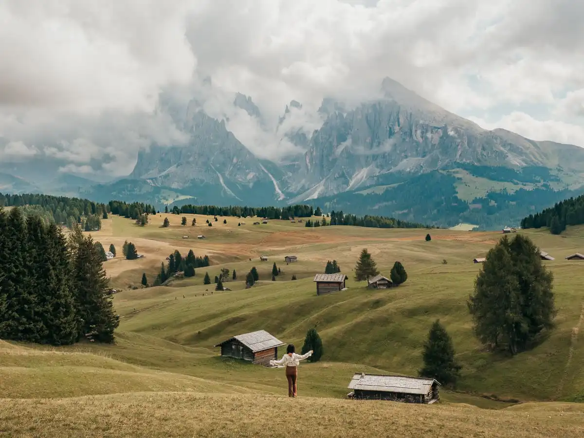 Woman standing in Alpe di siusi field