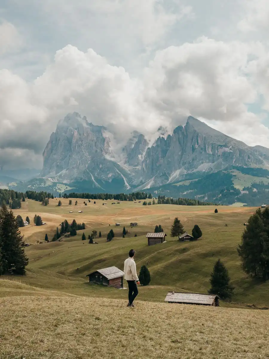 man standing in the field of alpe di siusi, one of the best things to do in the dolomites