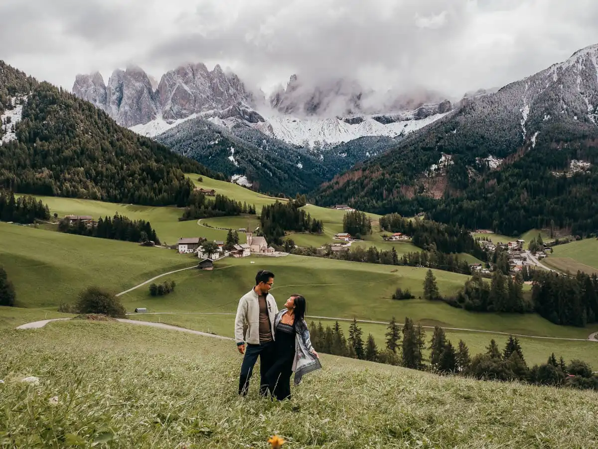 Val di funes church, couple standing in front of it