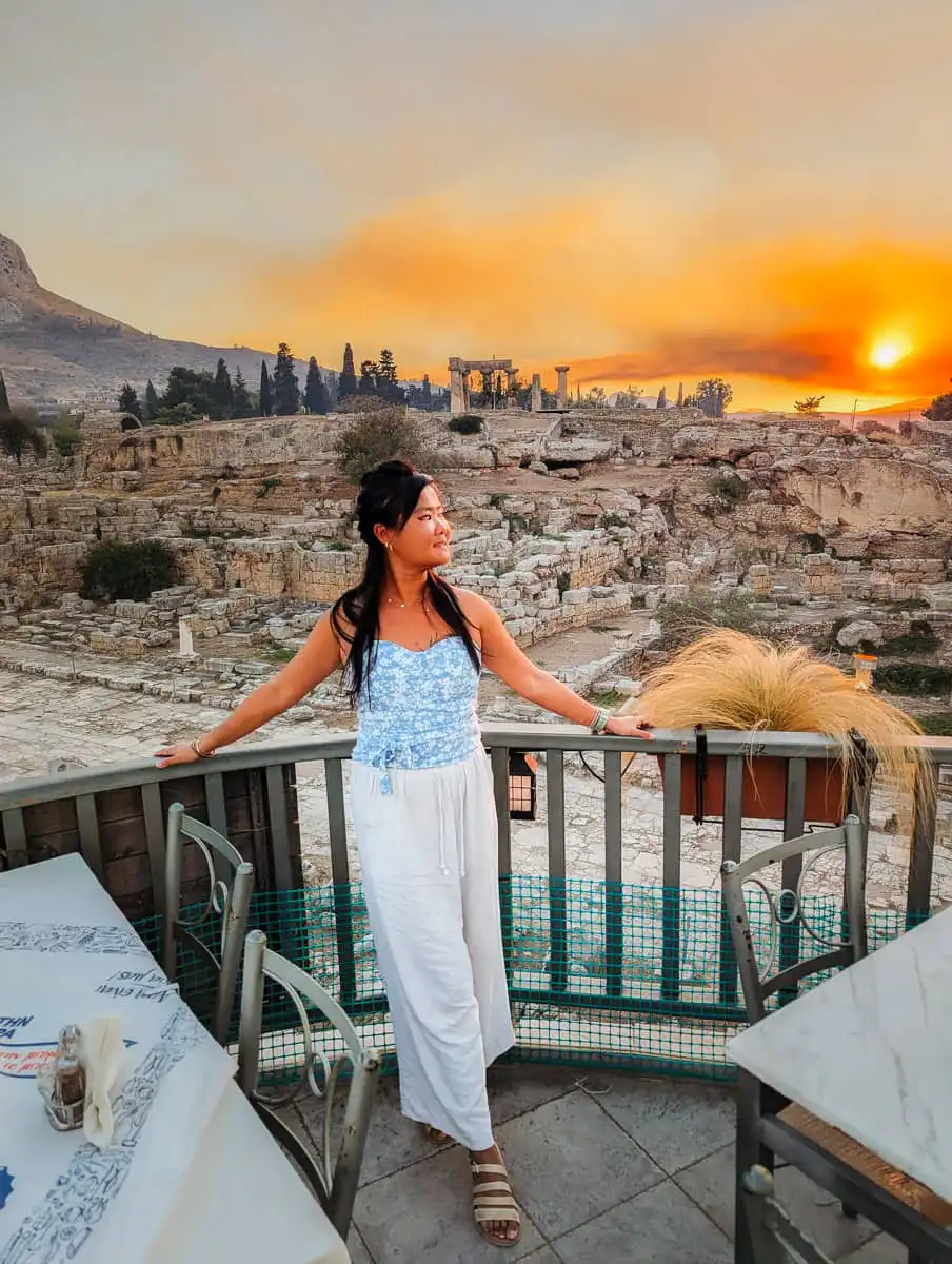 Standing on the terrace at sunset in front of Ancient Corinth