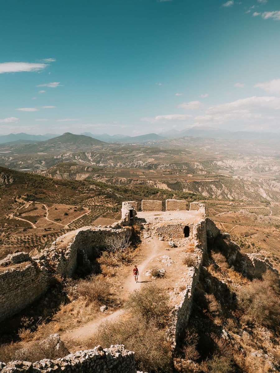 Corinth castle and man walking among the ruins