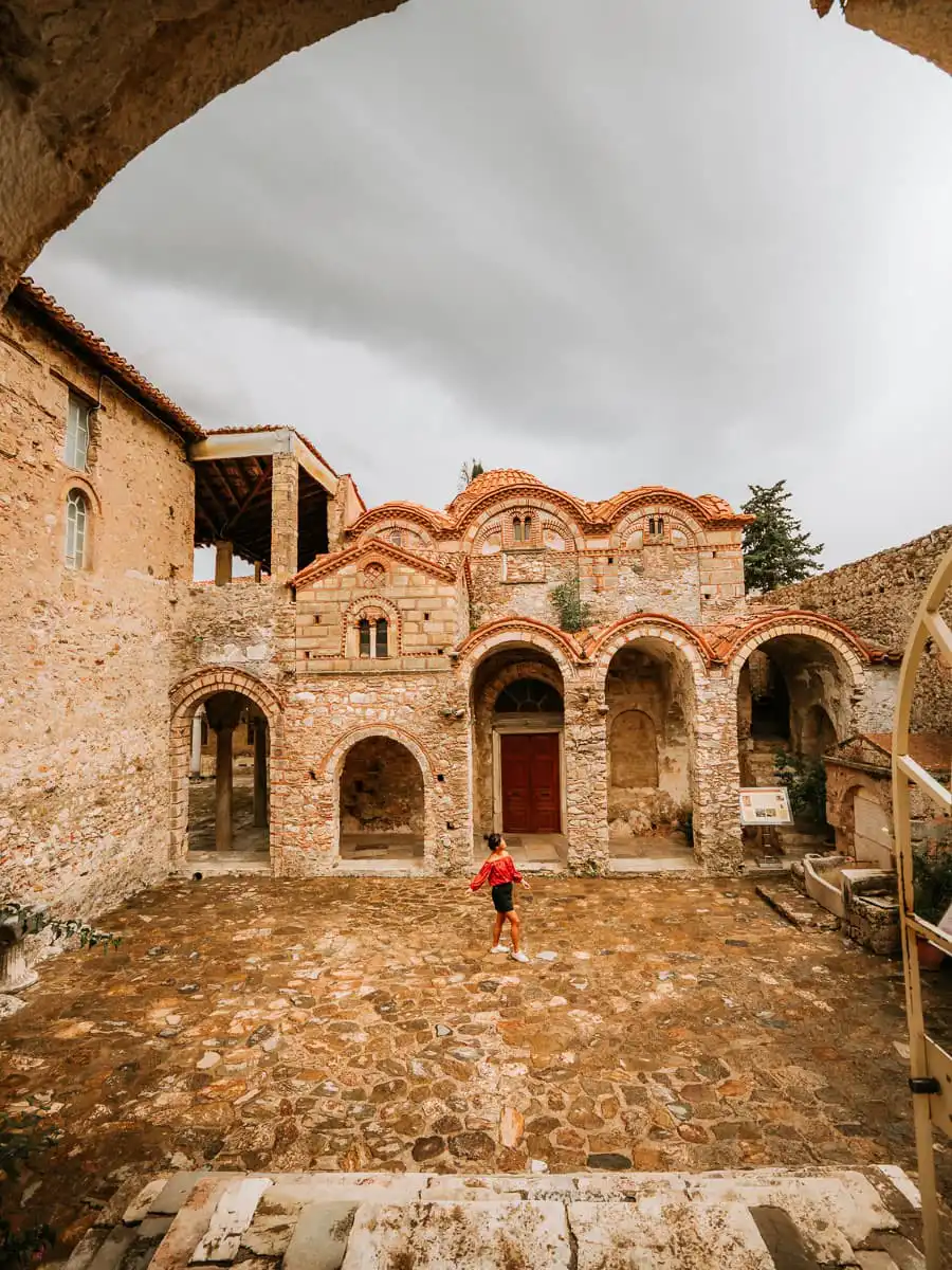 Standing inside courtyard of church at mystras