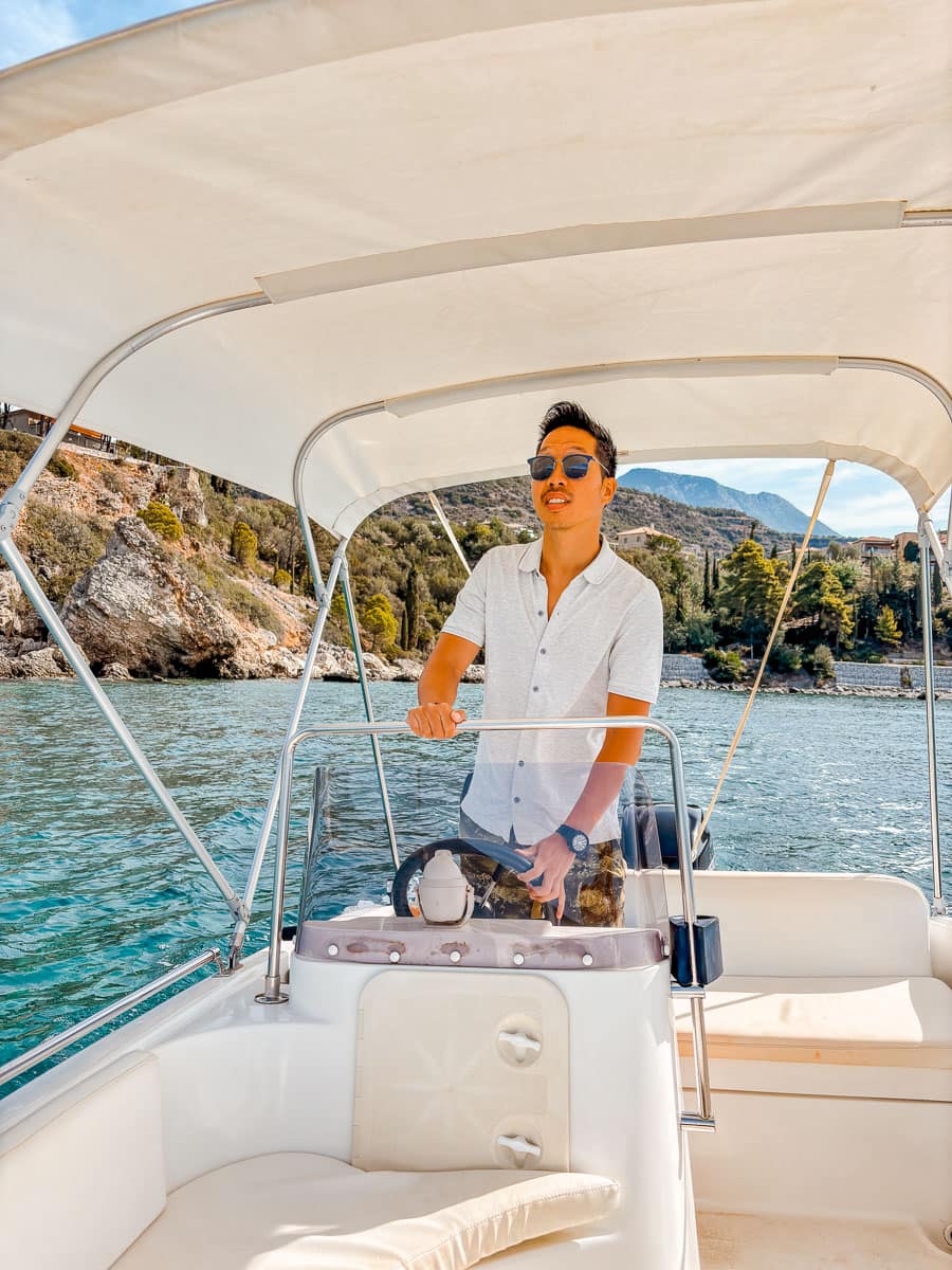 Driving the boat in Gytheo in Greece, one of our favourite activities during our Peloponnese road trip