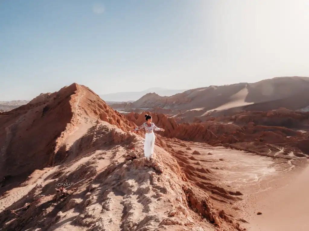 Standing at the dunes of Valle de la luna at sunset