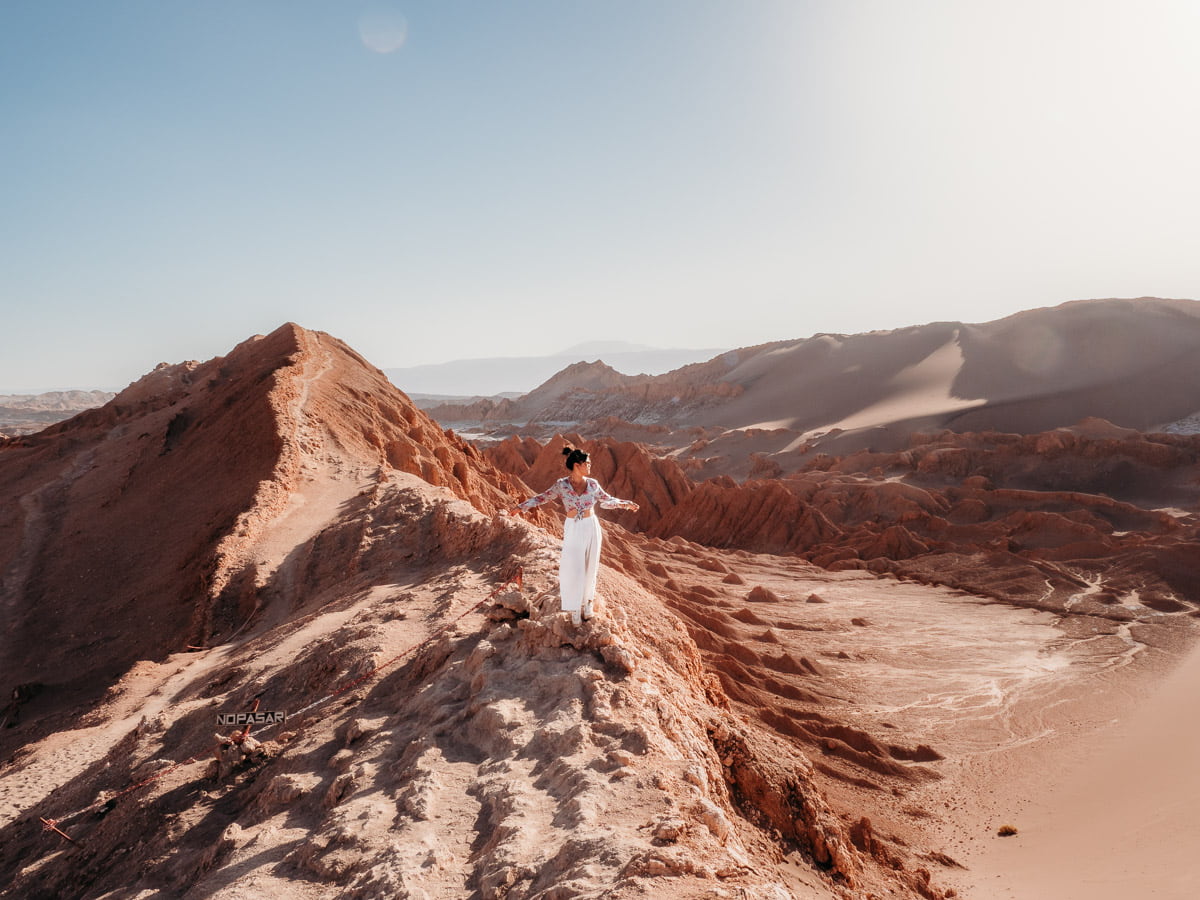 Standing at the dunes of Valle de la luna at sunset