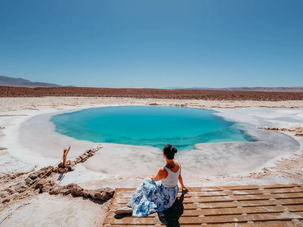Sitting in front of laguna baltinache, one of the best things to do in san pedro de atacama
