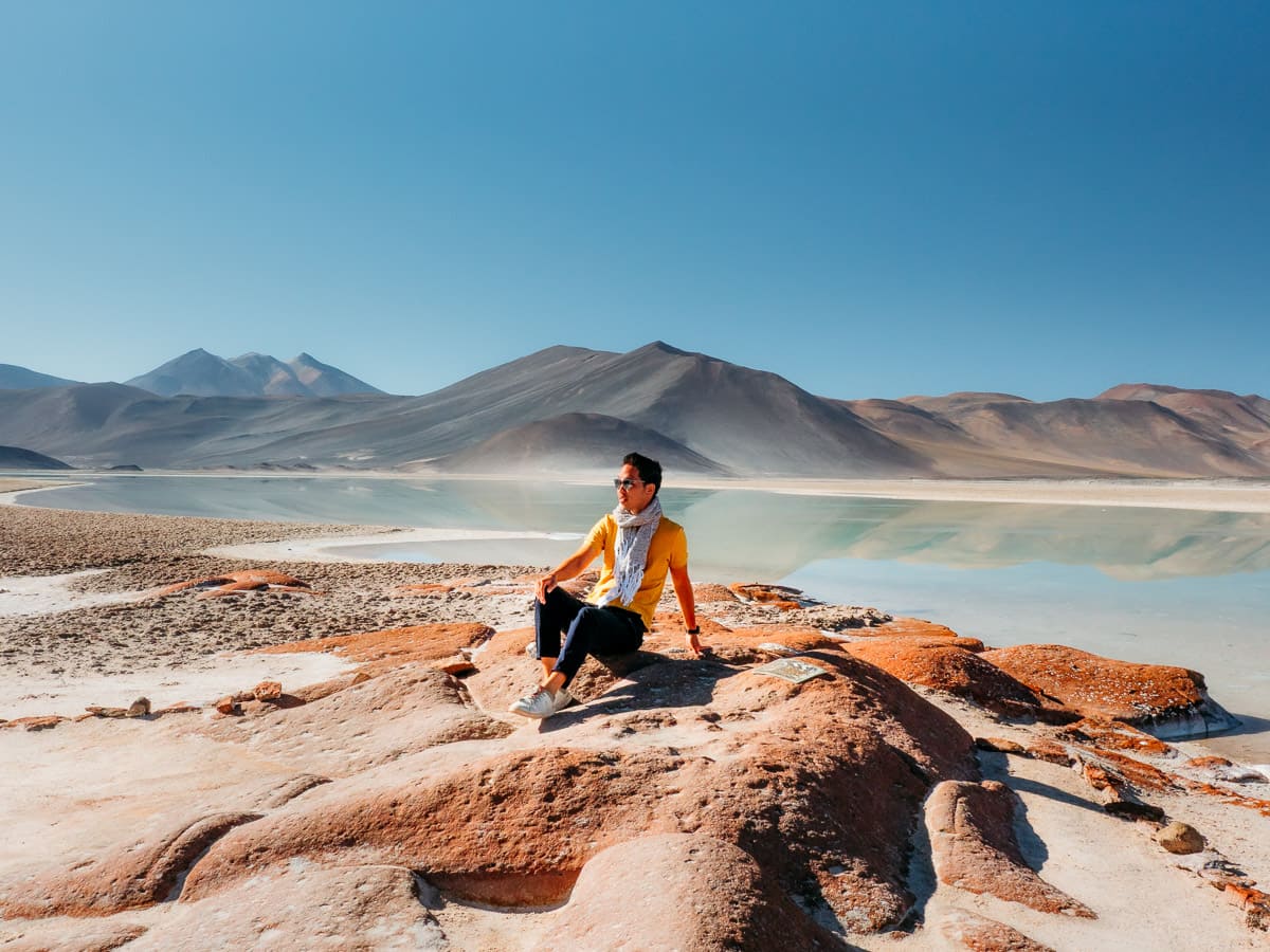 Man sitting on the red rocks of Piedras Rojas