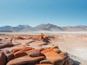 Woman standing on the red rocks of Piedras Rojas
