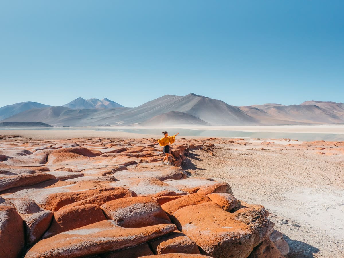 Woman standing on the red rocks of Piedras Rojas