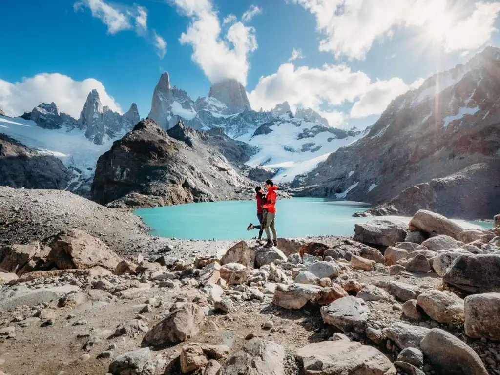 Man and woman standing at the summit of the Laguna Los Tres hike in Argentina