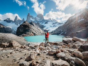 Man and woman standing at the summit of the Laguna Los Tres hike in Argentina