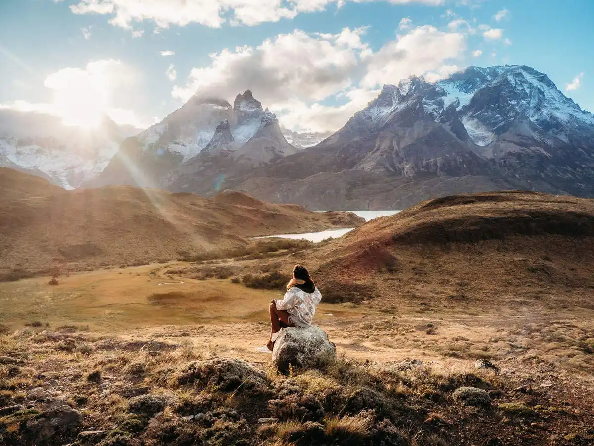 Sitting at sunset viewpoint during scenic drive in Torres del Paine in Chile Patagonia