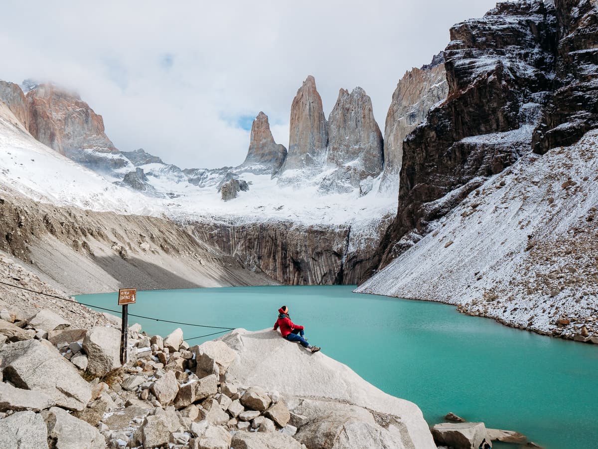 Sitting on the rock at the peak of Base de Torre hike