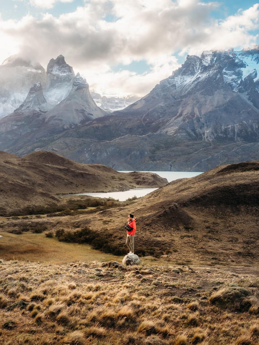 man standing on rock with the view of Torres del Paine