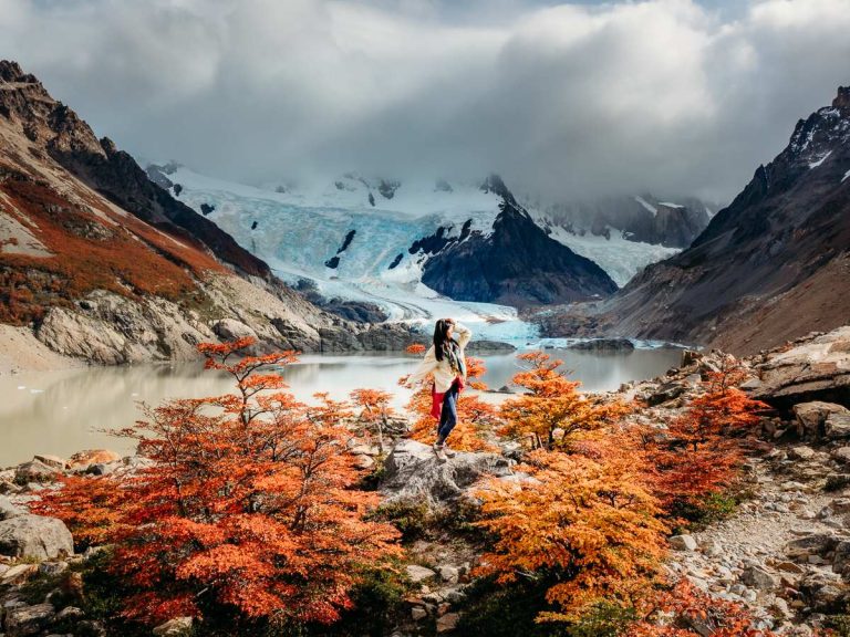 Woman standing among the fall foliage on the Laguna Torre hike in Argentina Patagonia