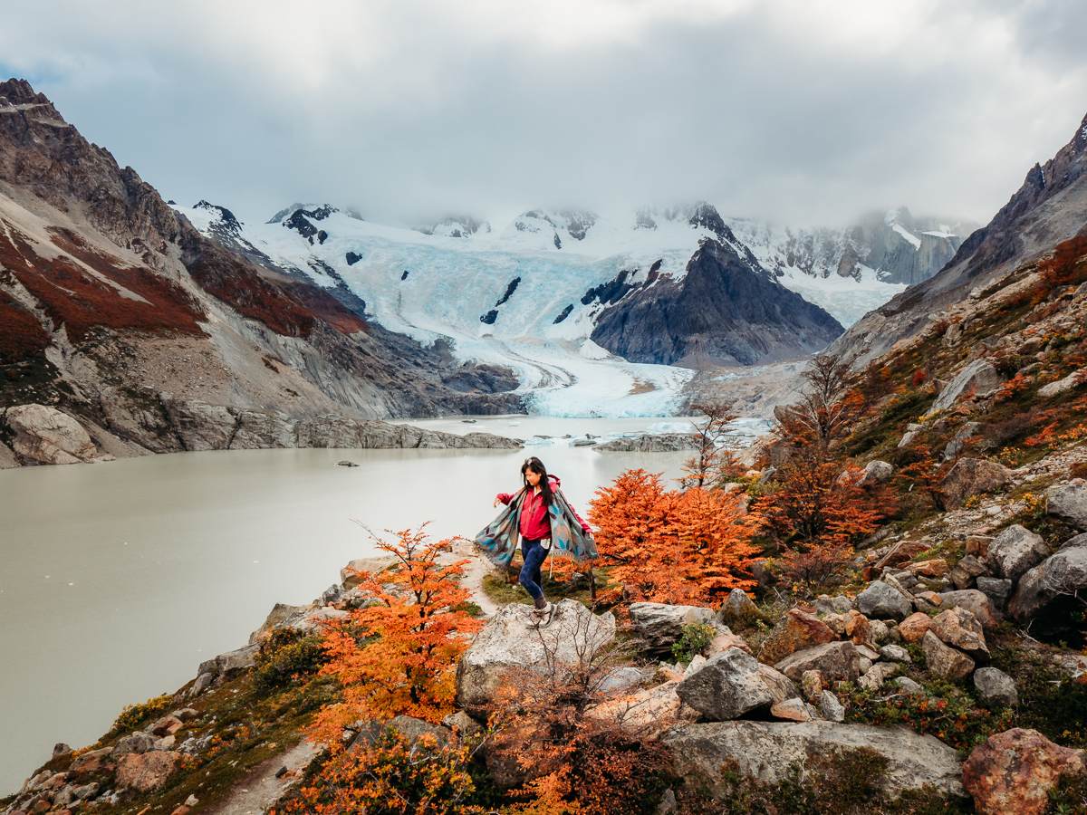 standing on a rock in front of fall foliage in argentina patagonia