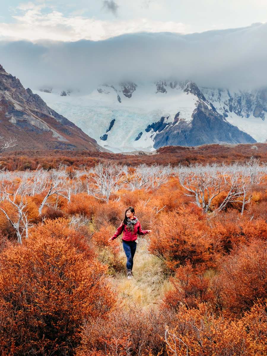 Woman standing in the forest in front of the mountains of Argentina Patagonia