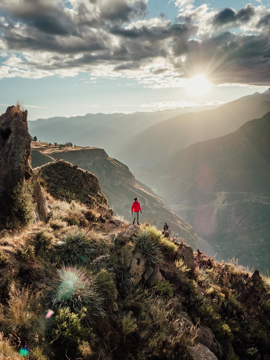man standing at the cliff of colca canyon