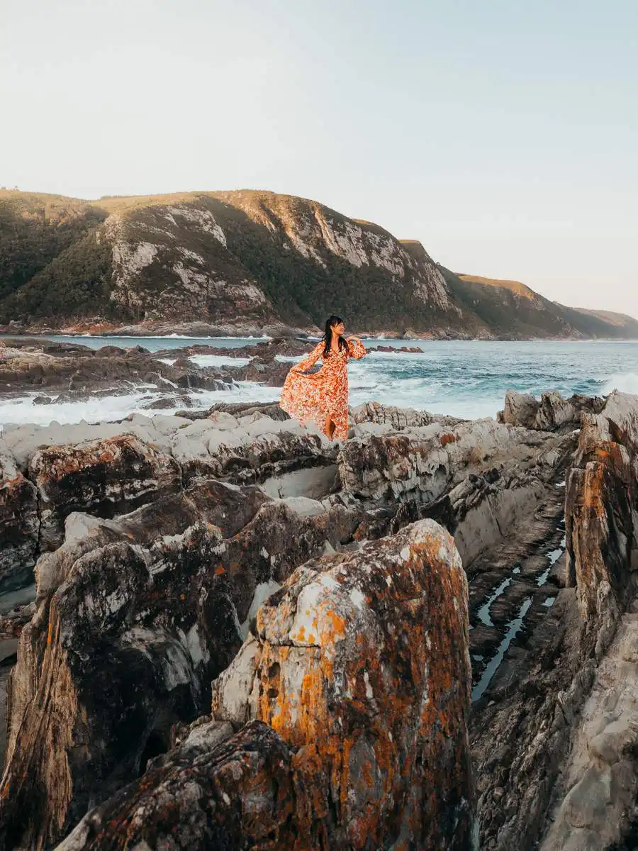 woman posing on the coastline of tsitsikamma national park