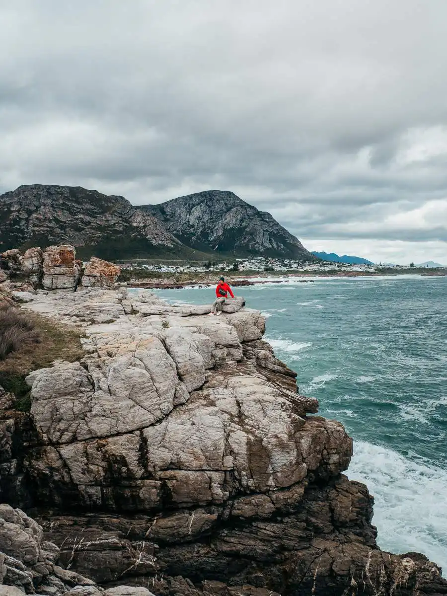 man standing on the cliffside in Hermanus on the Garden Route