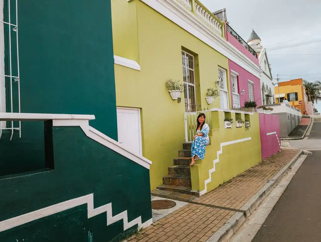 Woman sitting next to stairs in Cape Town's Bo-Kaap neighbourhoud